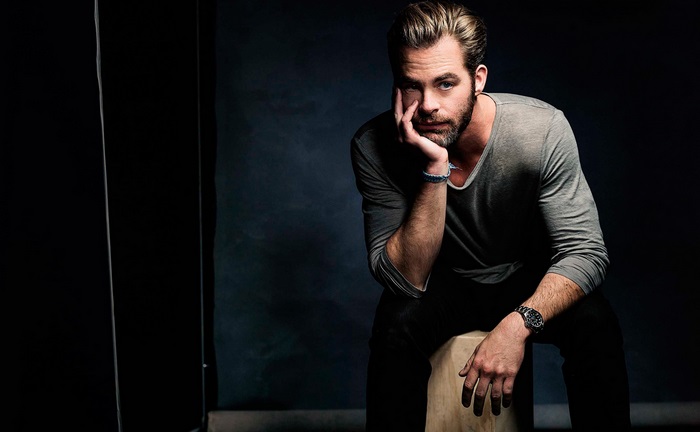 Chris Pine sitting on a stool