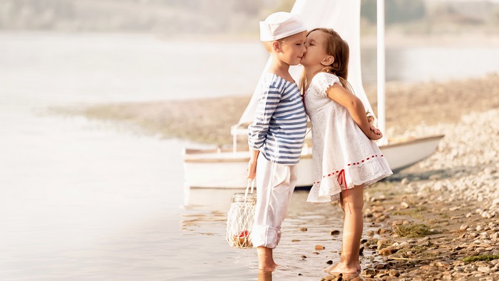 Cute boy and girl by the water