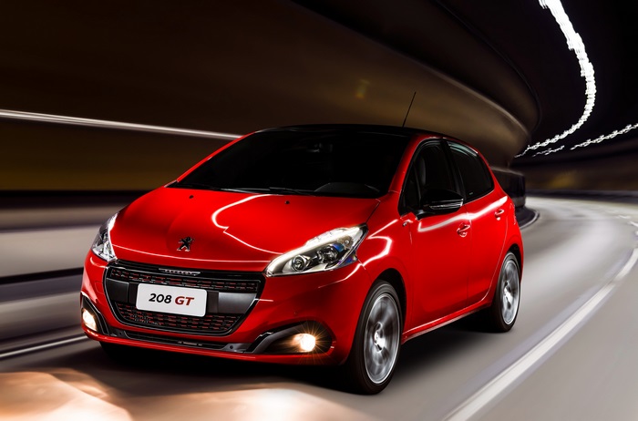 Red Peugeot 208 GT driving in a tunnel
