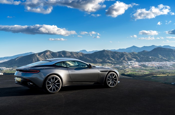 Aston Martin DB11 parked on a hill overlooking a town