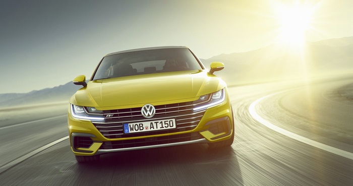 Yellow Volkswagen Arteon R Line driving on a road