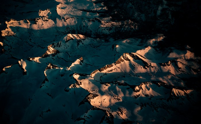 Aerial view of snow-covered mountains at sunset