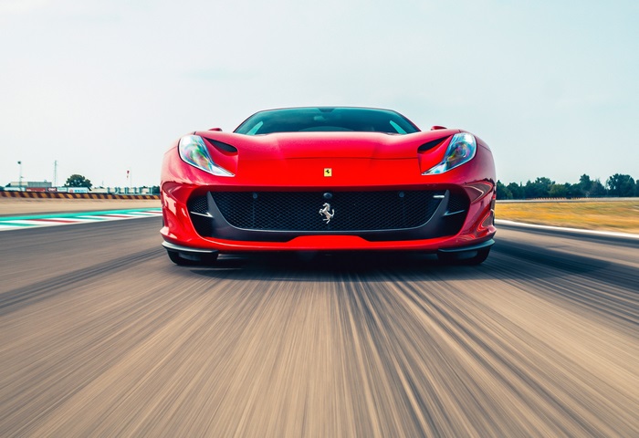 Red Ferrari 812 Superfast on a Racetrack