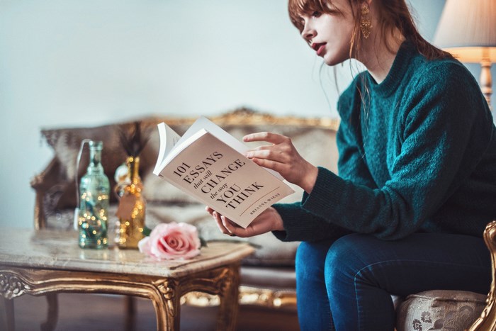 Woman reading "101 Essays That Will Change the Way You Think"