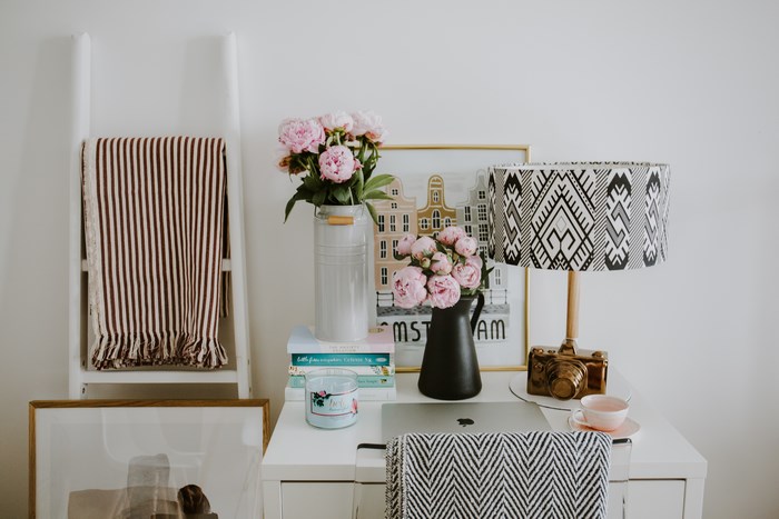 Desk with laptop, flowers, and lamp