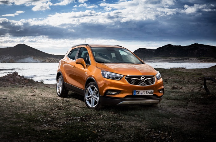 Orange Opel Mokka X parked by the sea