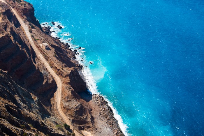 Aerial view of a coastal road and the blue ocean in Greece