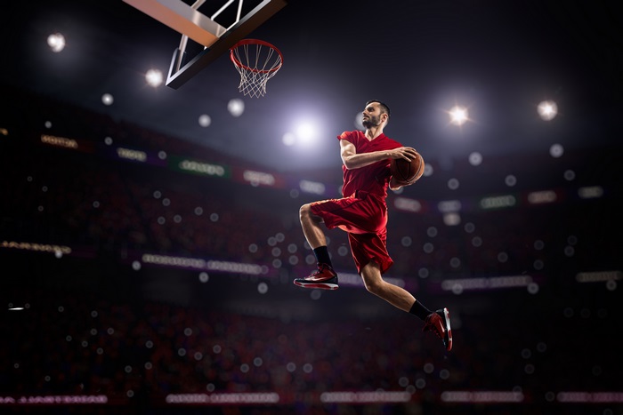 Basketball player dunking in a stadium 4K