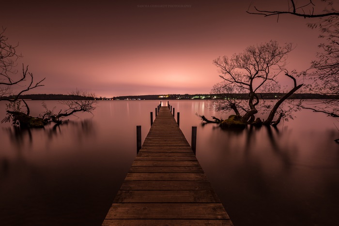 Wooden pier on a lake at dusk