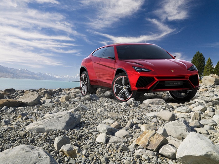 Red Lamborghini Urus on Rocky Shore