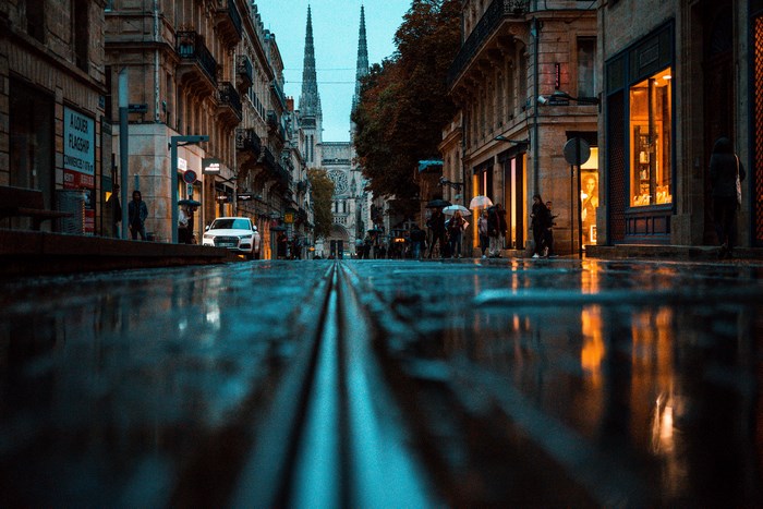 Street with puddles and cathedral in Bordeaux