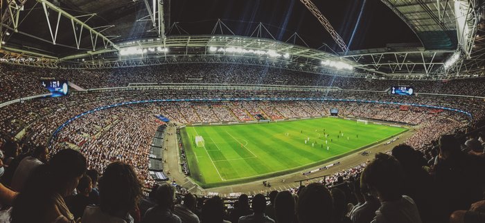 Soccer match in a packed stadium at night
