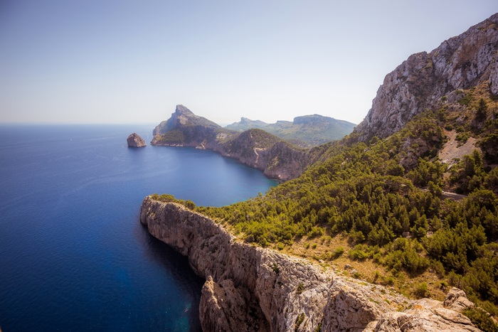 Coastline with rocky cliffs and green trees