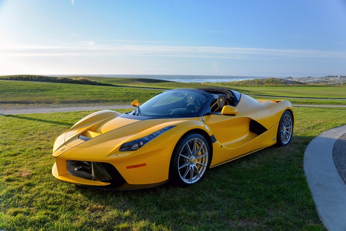 Yellow Ferrari LaFerrari Aperta on a golf course