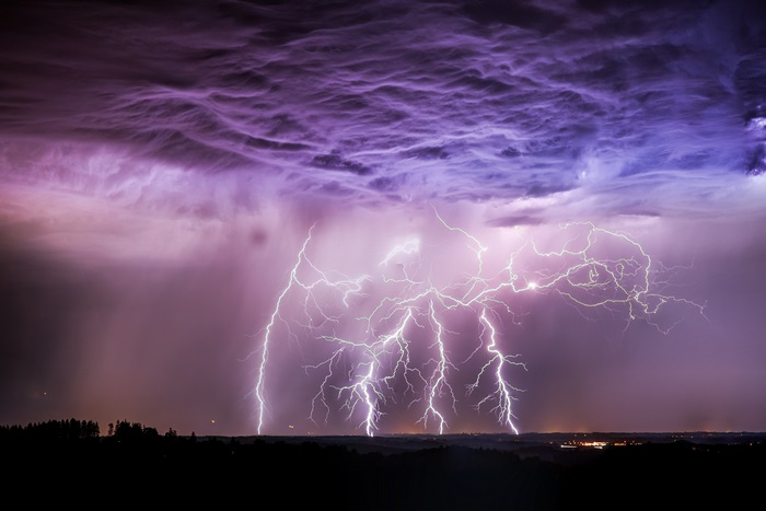 Lightning strikes over a dark landscape 4K