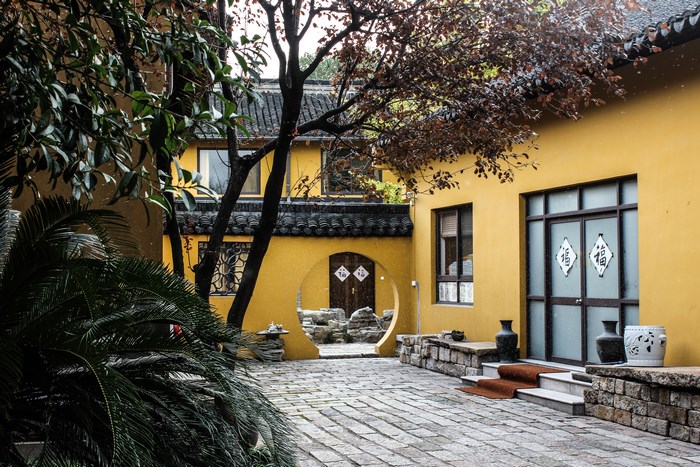 Yellow courtyard with traditional Chinese architecture and garden