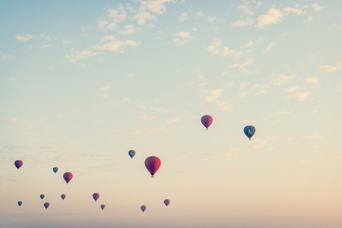 Hot air balloons flying in the sky at dawn