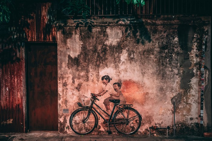 Children riding a bicycle mural in Penang, Malaysia