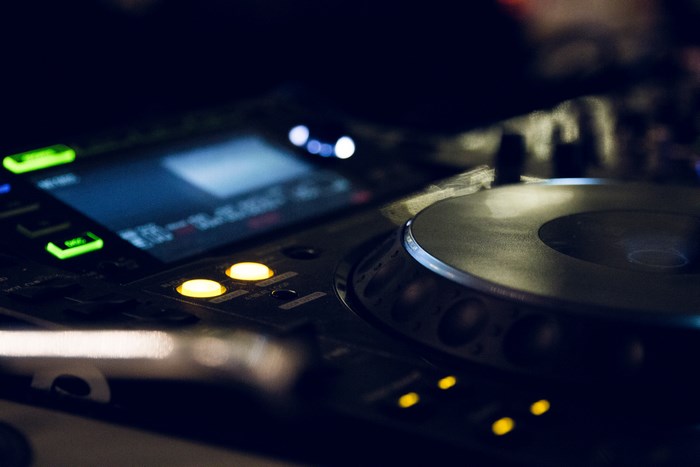 DJ turntable and mixer with glowing buttons