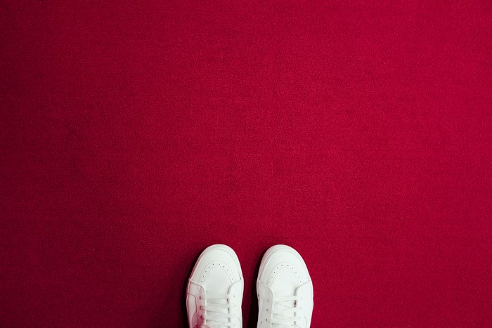 White sneakers on a red carpet