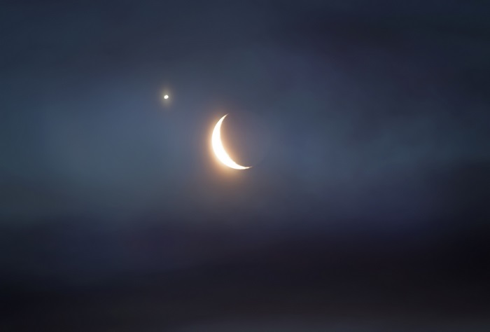 Crescent moon and planet in the night sky
