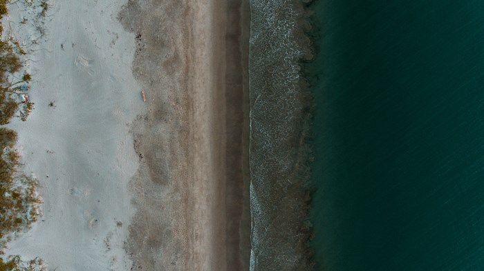 Aerial view of a sandy beach and ocean waves