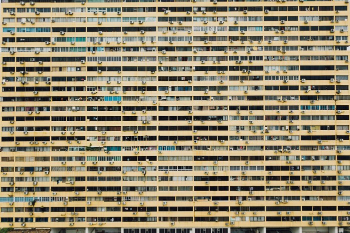 Yellow apartment building with many windows and balconies