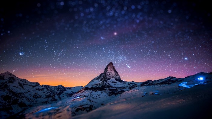 Matterhorn mountain under starry night sky