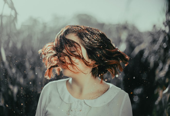 Woman with glitter in her hair outdoors