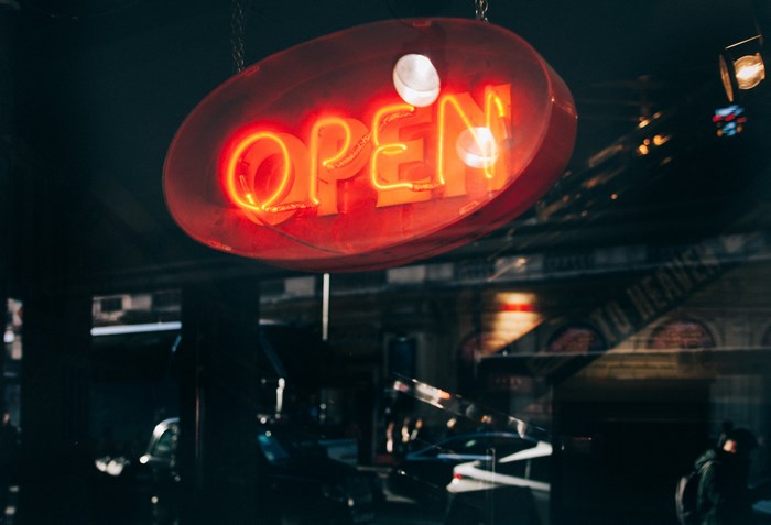 Red neon "OPEN" sign hanging at night