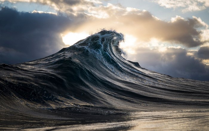 Sunrise over Ocean Waves with Dramatic Clouds