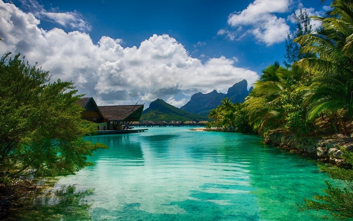 Tropical resort with overwater bungalows and mountains
