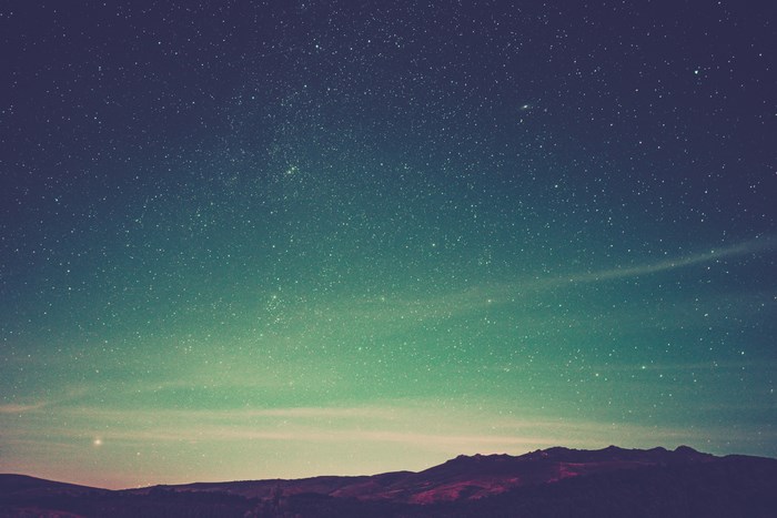 Starry night sky over mountains