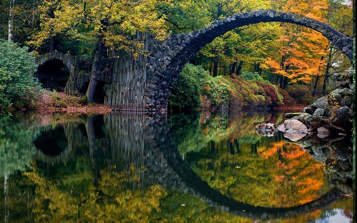 Rakotzbrücke bridge over a lake in autumn