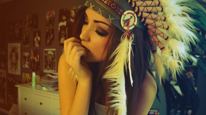 Brunette woman wearing a Native American headdress