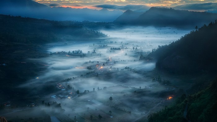 Misty valley village at sunrise in Indonesia