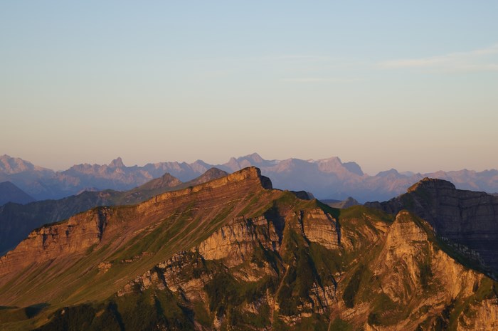 Mountain range at sunrise with golden hour light