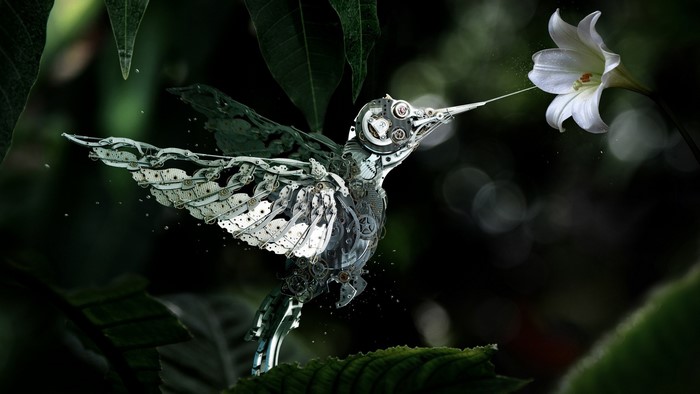 Mechanical hummingbird feeding from a white lily