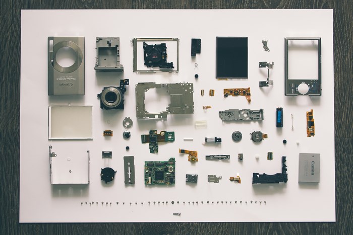 Canon Camera Parts Arranged on White Surface
