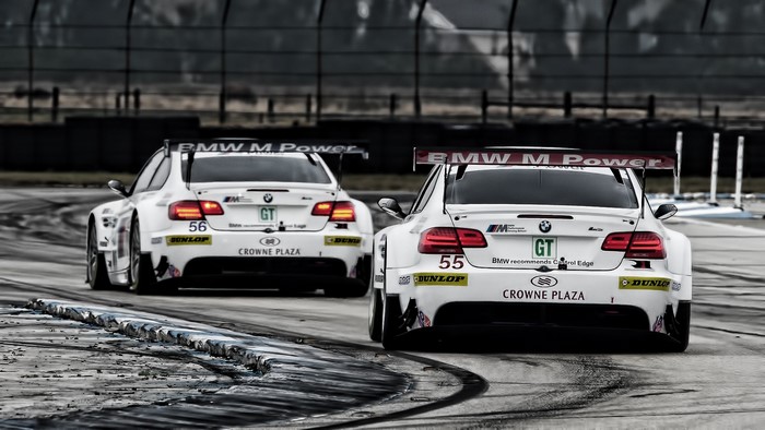 Two BMW M3 GT race cars on a track