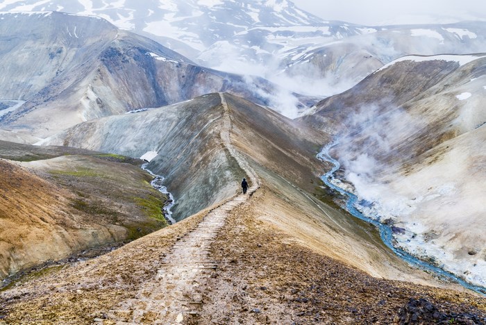 Hiker on a path in Kerlingarfjoll, Iceland with steam