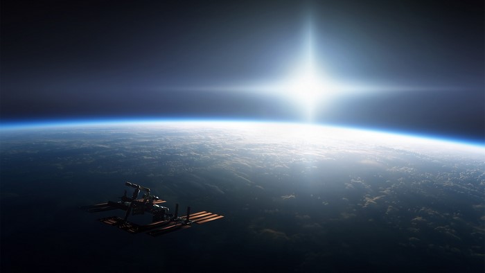 Satellite orbiting Earth with bright sun