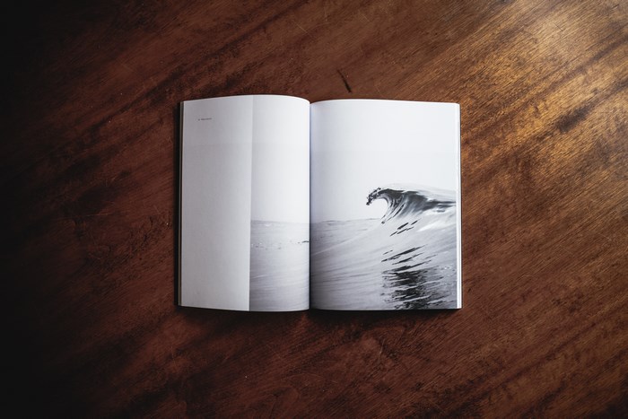 Open Magazine Flatlay with Black and White Ocean Wave
