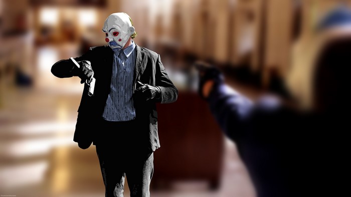 The Joker from The Dark Knight holding a gun