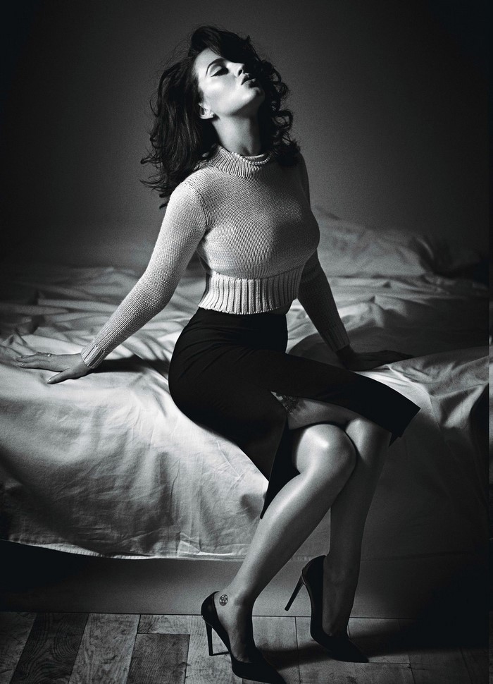Katy Perry sitting on a bed