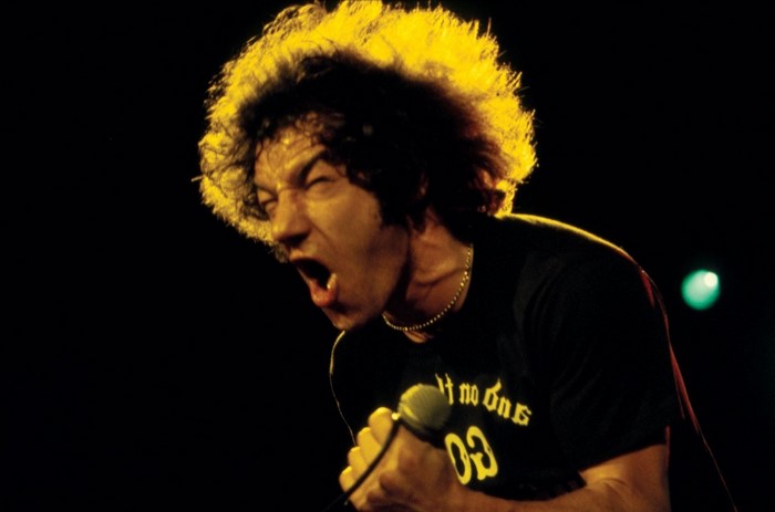 Brian Johnson of AC/DC singing into a microphone