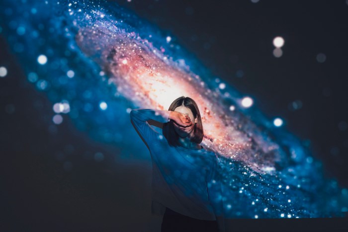 Woman with galaxy projected on her face