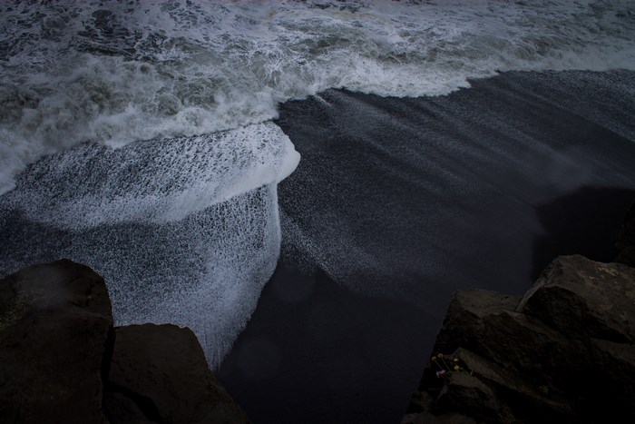 Waves crashing on black sand beach in Iceland