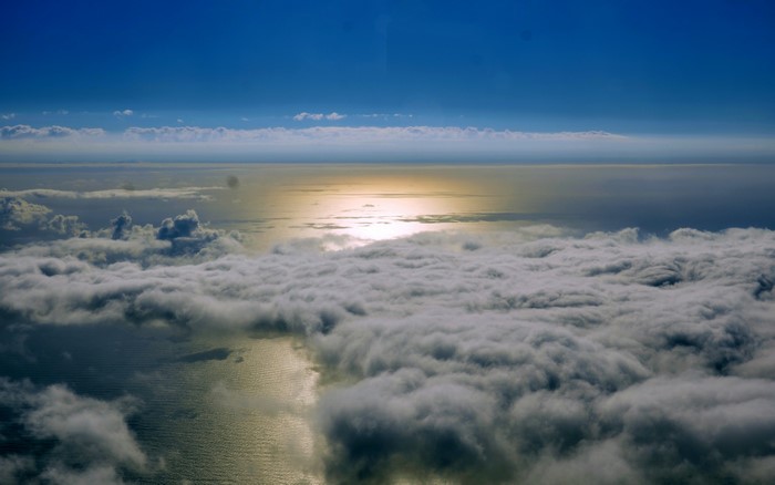 Aerial view of clouds over the sea at sunset