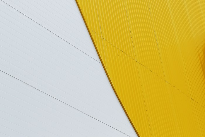 Abstract yellow and white corrugated wall
